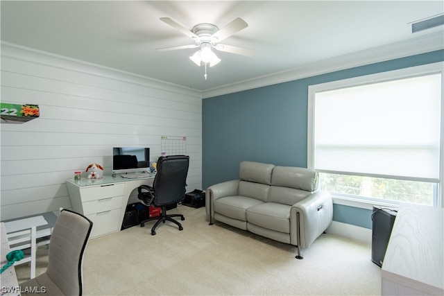 carpeted office space with ornamental molding and ceiling fan