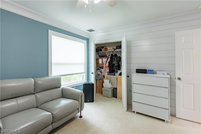 interior space featuring light carpet, crown molding, and ceiling fan