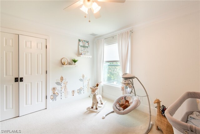 interior space featuring crown molding, ceiling fan, and light colored carpet