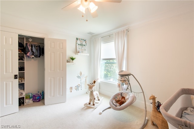 interior space featuring crown molding, ceiling fan, and light carpet