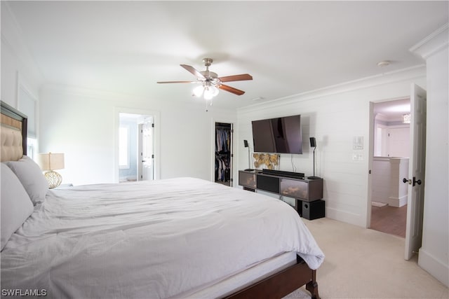 bedroom with a closet, ceiling fan, light carpet, a spacious closet, and ensuite bathroom