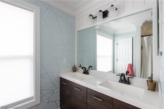 bathroom featuring plenty of natural light, dual bowl vanity, and ornamental molding