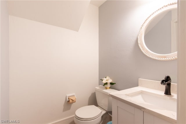 bathroom with toilet and vanity