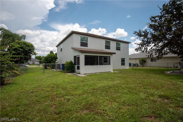 rear view of house with a yard