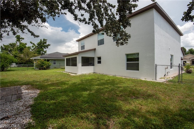 back of house with a yard