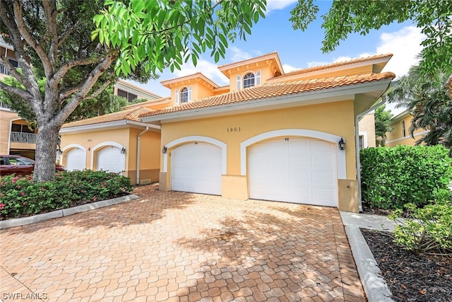 mediterranean / spanish-style house featuring a garage