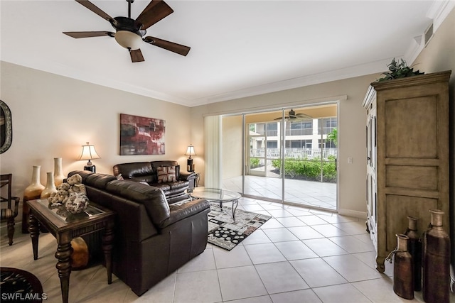 tiled living room with ornamental molding and ceiling fan