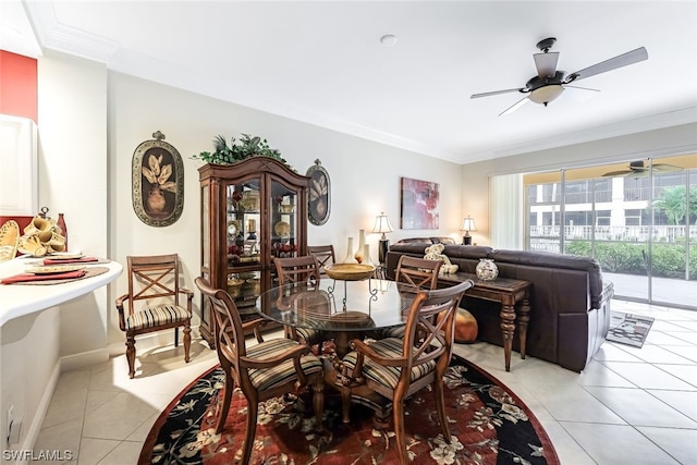 dining area featuring light tile floors, crown molding, and ceiling fan