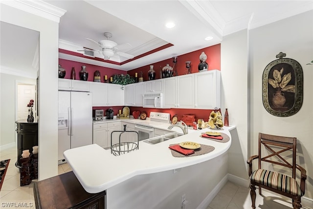 kitchen featuring ceiling fan, white appliances, sink, light tile floors, and a breakfast bar area