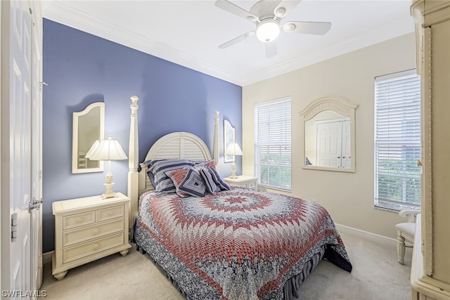 bedroom with light colored carpet, multiple windows, ceiling fan, and crown molding