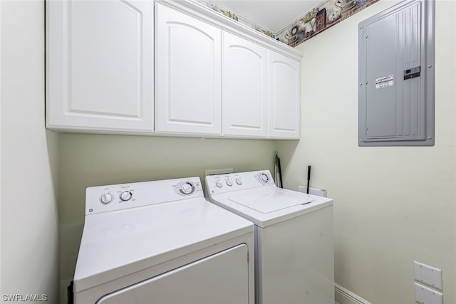 clothes washing area featuring cabinets and washing machine and dryer