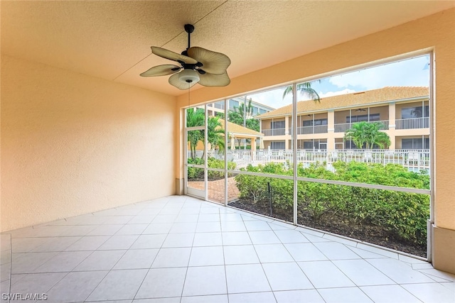 unfurnished sunroom featuring plenty of natural light and ceiling fan