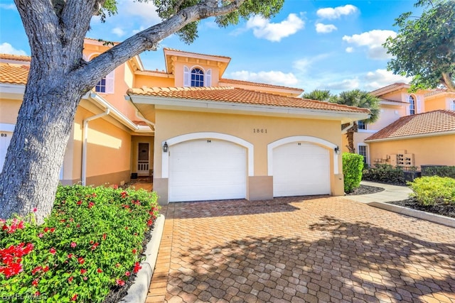 mediterranean / spanish home featuring a garage