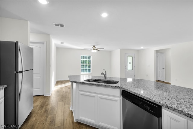 kitchen with ceiling fan, white cabinets, stainless steel appliances, dark wood-type flooring, and light stone countertops