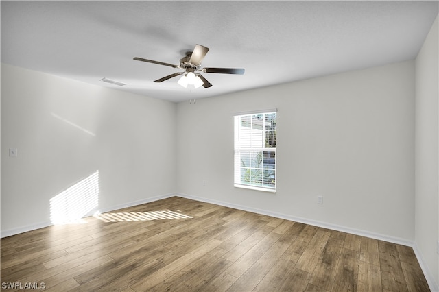 spare room with ceiling fan and light hardwood / wood-style flooring