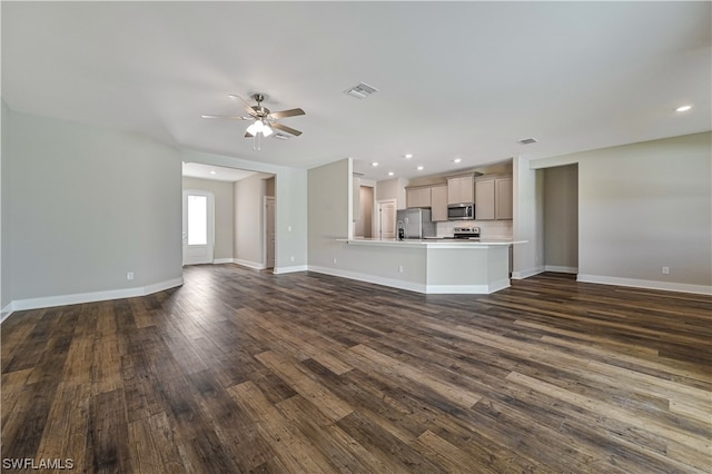 unfurnished living room featuring dark hardwood / wood-style flooring and ceiling fan