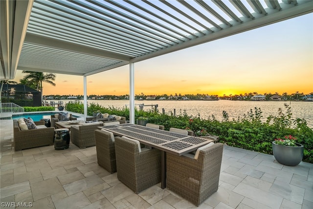 patio terrace at dusk featuring a water view, a pergola, and an outdoor hangout area