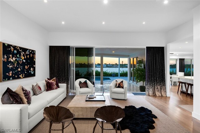 living room with a water view and light wood-type flooring