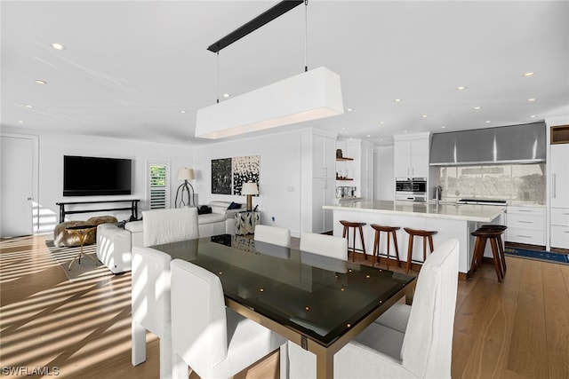 dining space with light wood-type flooring