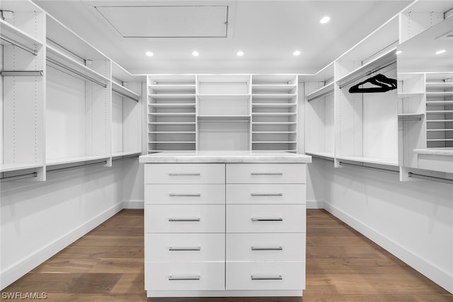 spacious closet with dark wood-type flooring