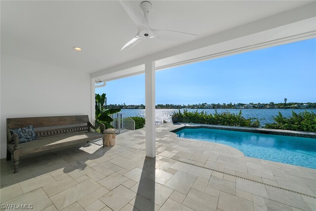 view of pool featuring a patio, a water view, and ceiling fan