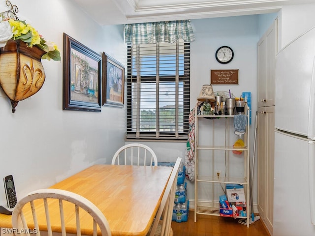 dining room featuring dark wood-type flooring and crown molding