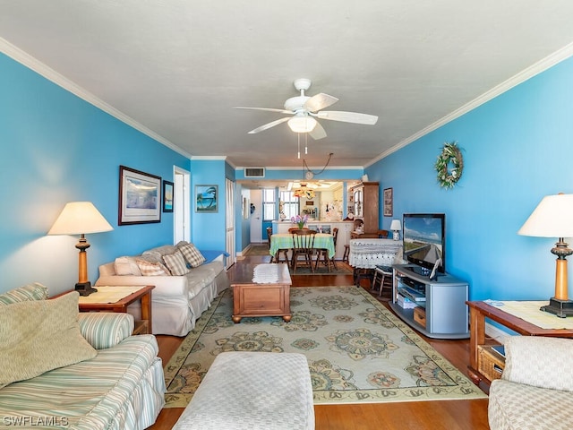 living room featuring crown molding, ceiling fan with notable chandelier, and light wood-type flooring