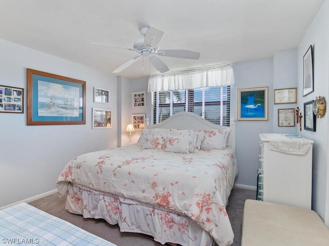 bedroom featuring dark carpet and ceiling fan