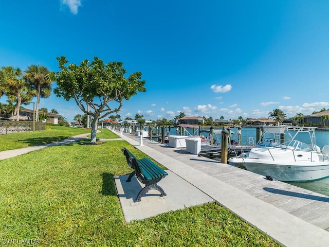 view of dock featuring a water view and a yard