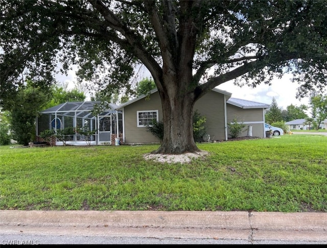 view of front facade with a lanai and a front yard