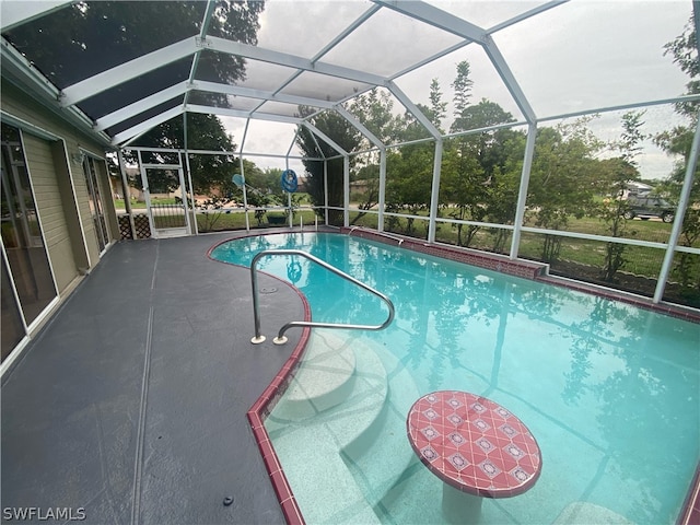 view of swimming pool with glass enclosure