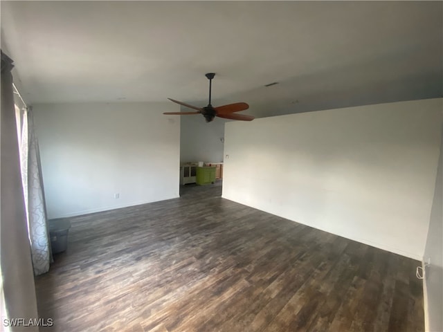 spare room featuring dark hardwood / wood-style floors, ceiling fan, and lofted ceiling