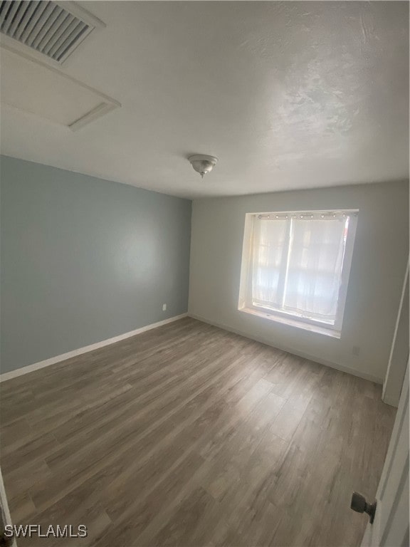 unfurnished room featuring dark wood-type flooring