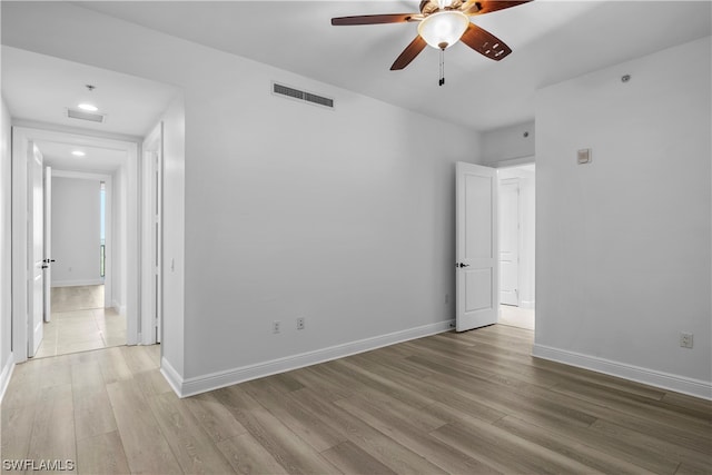 unfurnished room with ceiling fan and light hardwood / wood-style floors