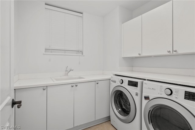 washroom with cabinets, sink, and separate washer and dryer