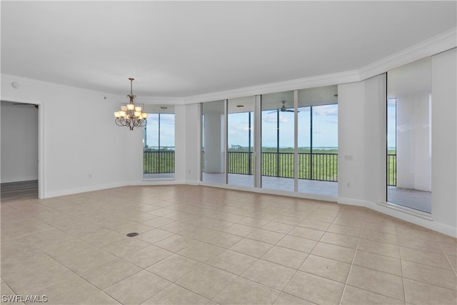 tiled spare room featuring crown molding, a wealth of natural light, expansive windows, and an inviting chandelier