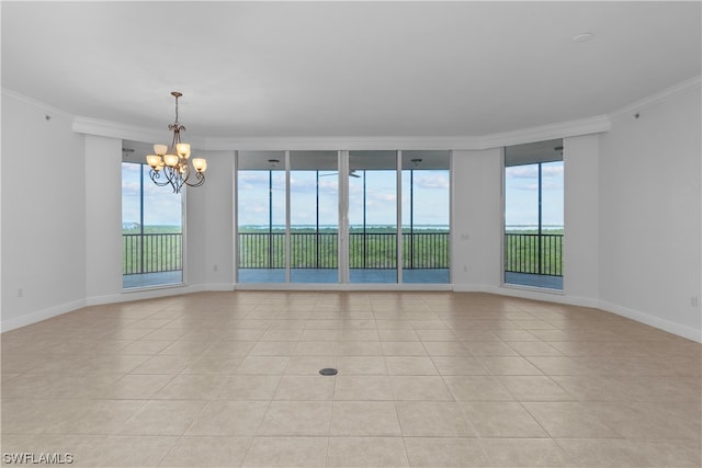 tiled empty room with crown molding, an inviting chandelier, and a wall of windows