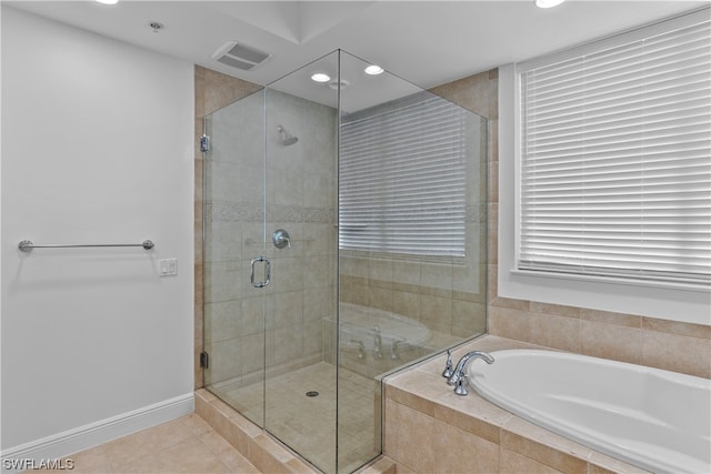 bathroom with plus walk in shower and tile patterned flooring