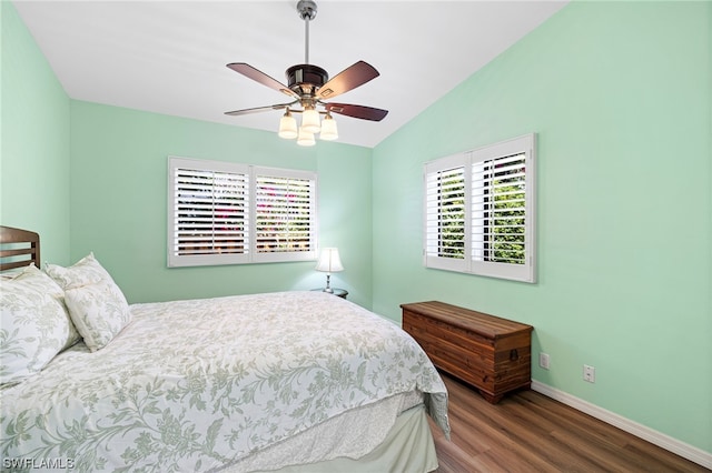 bedroom with ceiling fan, dark hardwood / wood-style flooring, and vaulted ceiling