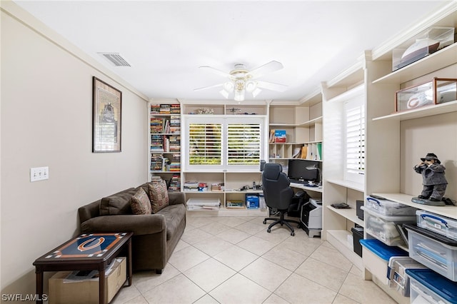 tiled home office featuring ceiling fan and ornamental molding