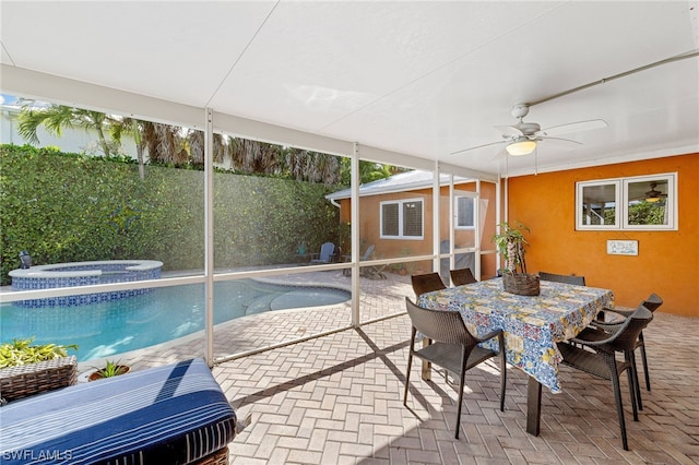 sunroom featuring ceiling fan