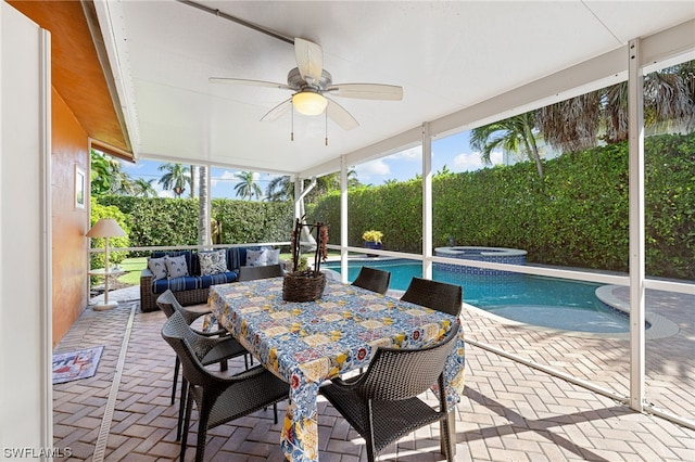 sunroom featuring ceiling fan