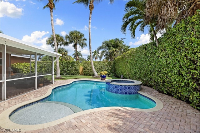 view of pool with a sunroom and an in ground hot tub