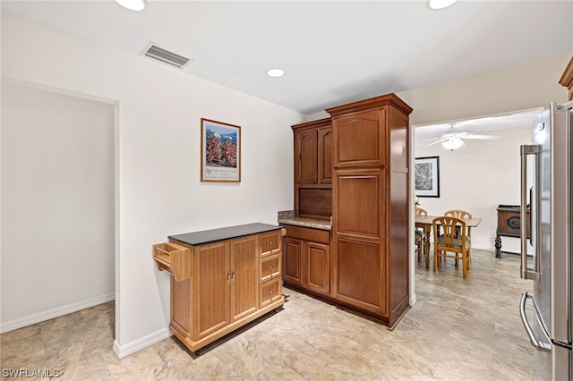 kitchen featuring high end refrigerator and ceiling fan