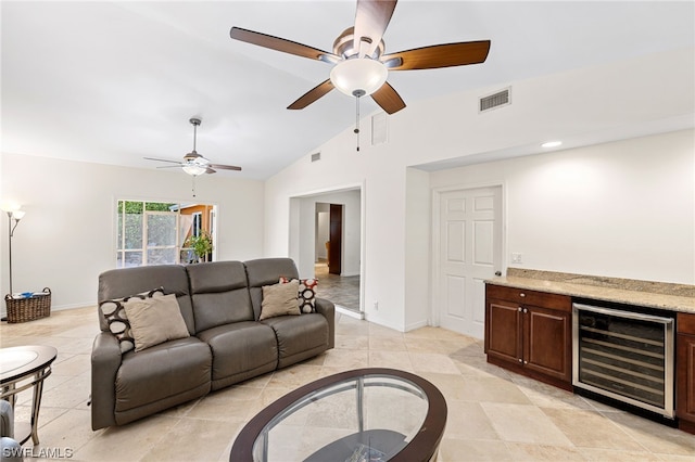 living room featuring high vaulted ceiling, light tile patterned floors, and beverage cooler