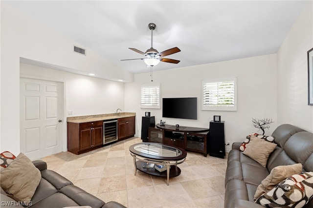 living room with wine cooler, ceiling fan, lofted ceiling, and sink