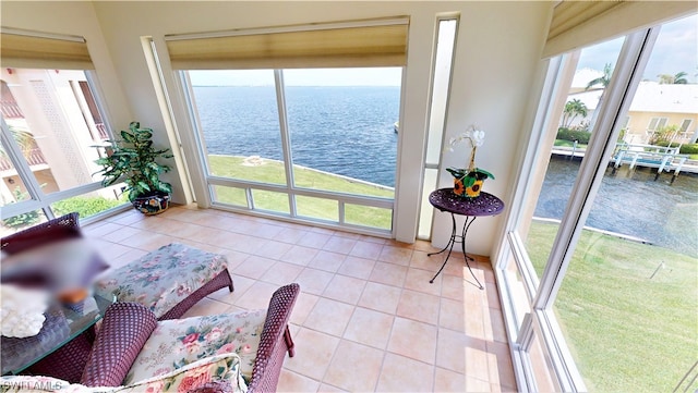 sunroom / solarium featuring plenty of natural light and a water view