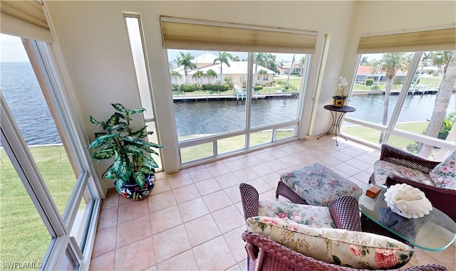 sunroom / solarium featuring a water view and a healthy amount of sunlight