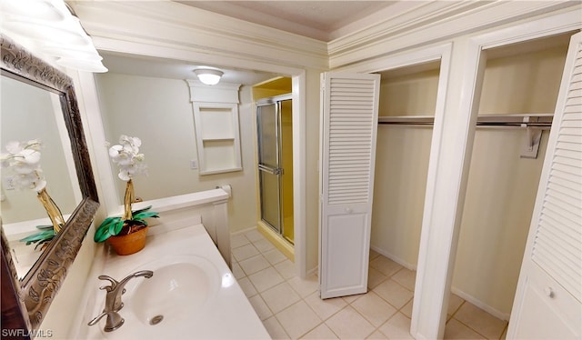 bathroom with an enclosed shower, vanity, and tile floors