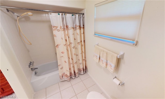 bathroom with tile flooring and shower / bath combo with shower curtain